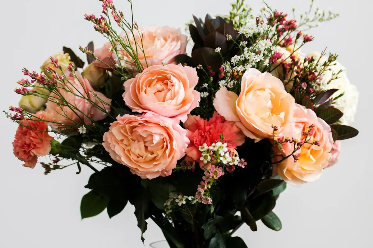Close-up of dried flowers arranged in a ceramic vase with natural light