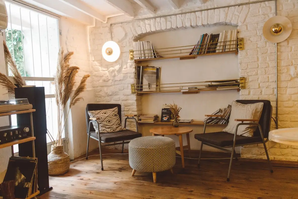 How to Style Photo Frames Without Making Your Walls Look Like a Storage Unit 3 Frames leaned against a wall on a shelf with decorative objects